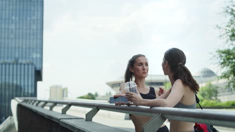 video of two athletic women talking before training