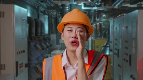 woman engineer whispering in industrial setting