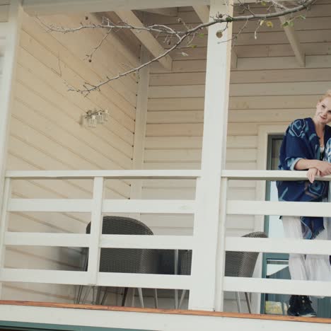 Mom-and-daughter-stand-on-the-terrace-of-their-country-house-1