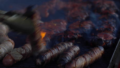 bbq food, chicken, hotdogs being char grilled on an open summer time barbeque