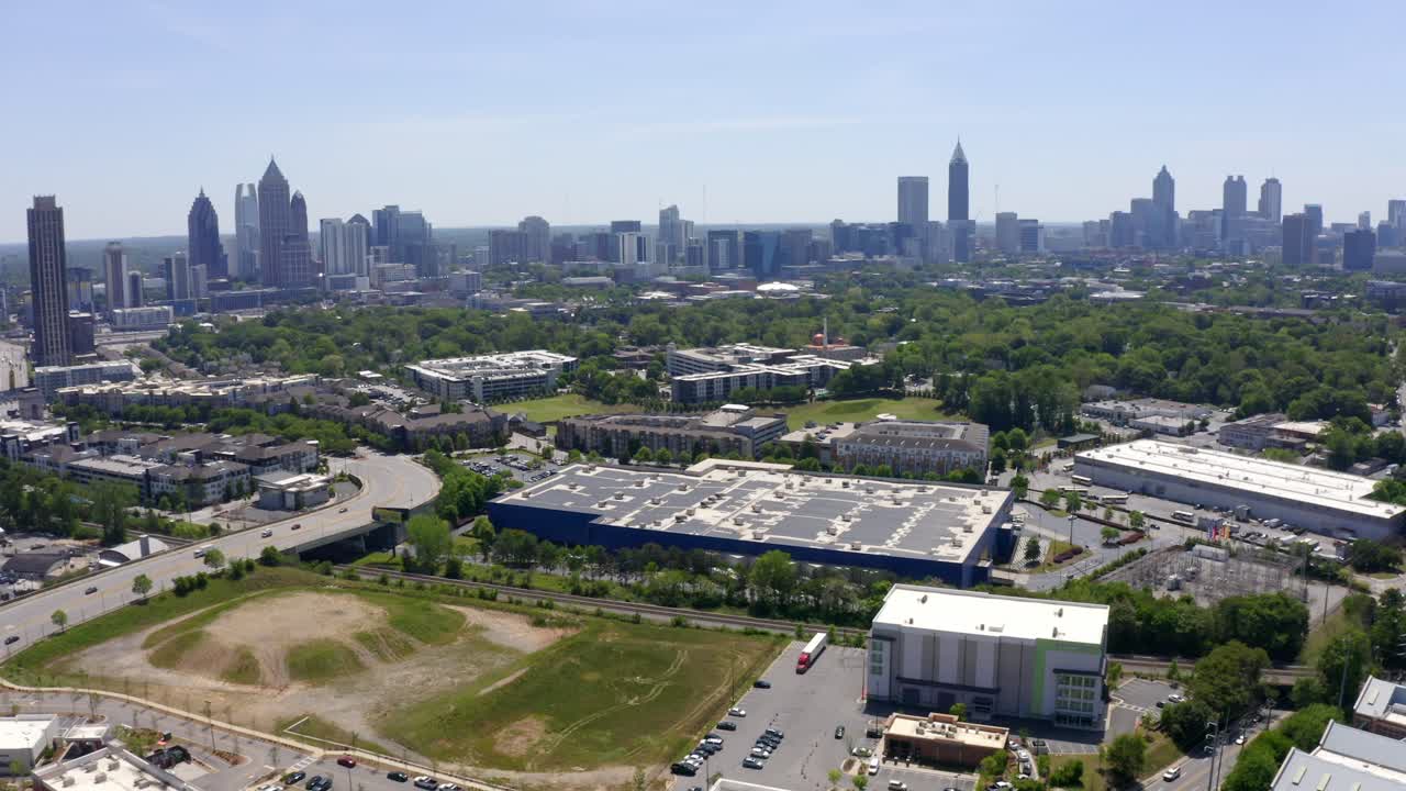 Drone shot of Atlanta Georgia neighborhood with skylines and skyscrapers in view, Urban city parks and landscape