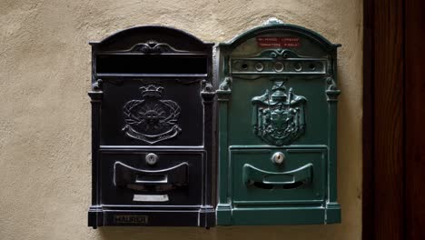 two vintage mailboxes on a wall