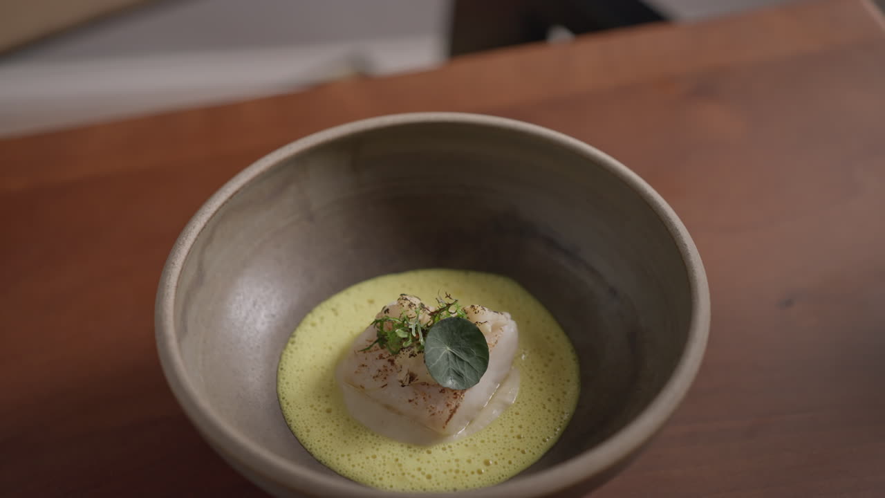 Close-up of a gourmet fish dish in a bowl
