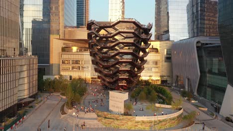 aerial of tourists climbing the vessel an artistic outdoor spiral staircase in the hudson yards of new york city new york