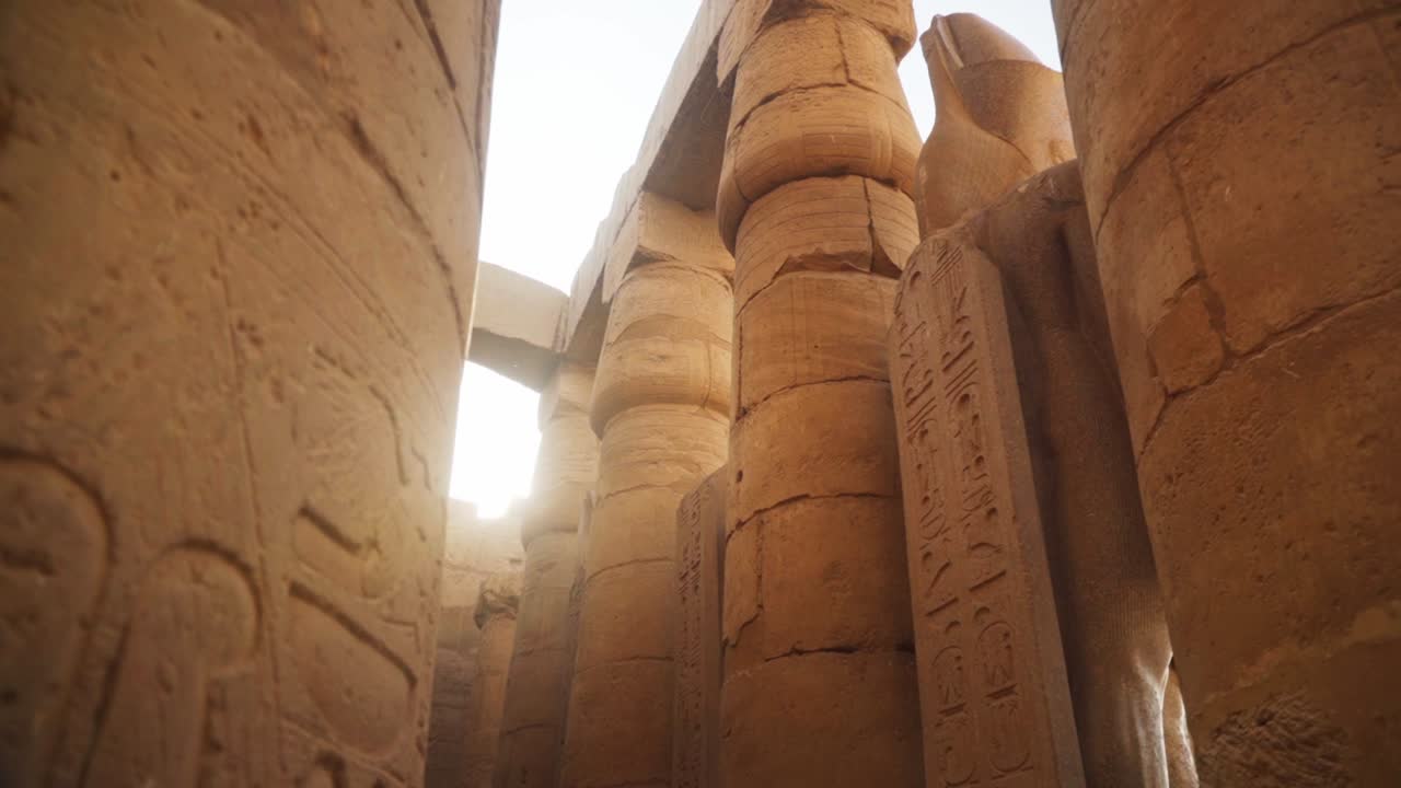 Detailed stone carving in the Karnak Temple.
Slow sideways slide revealing sun flare.