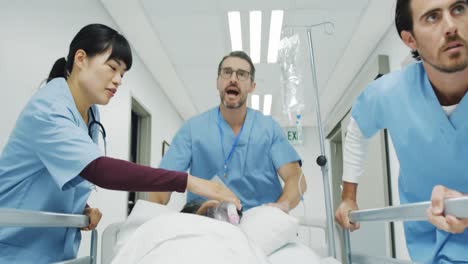 Hospital-staff-pushing-patient-in-bed-during-an-emergency-4k