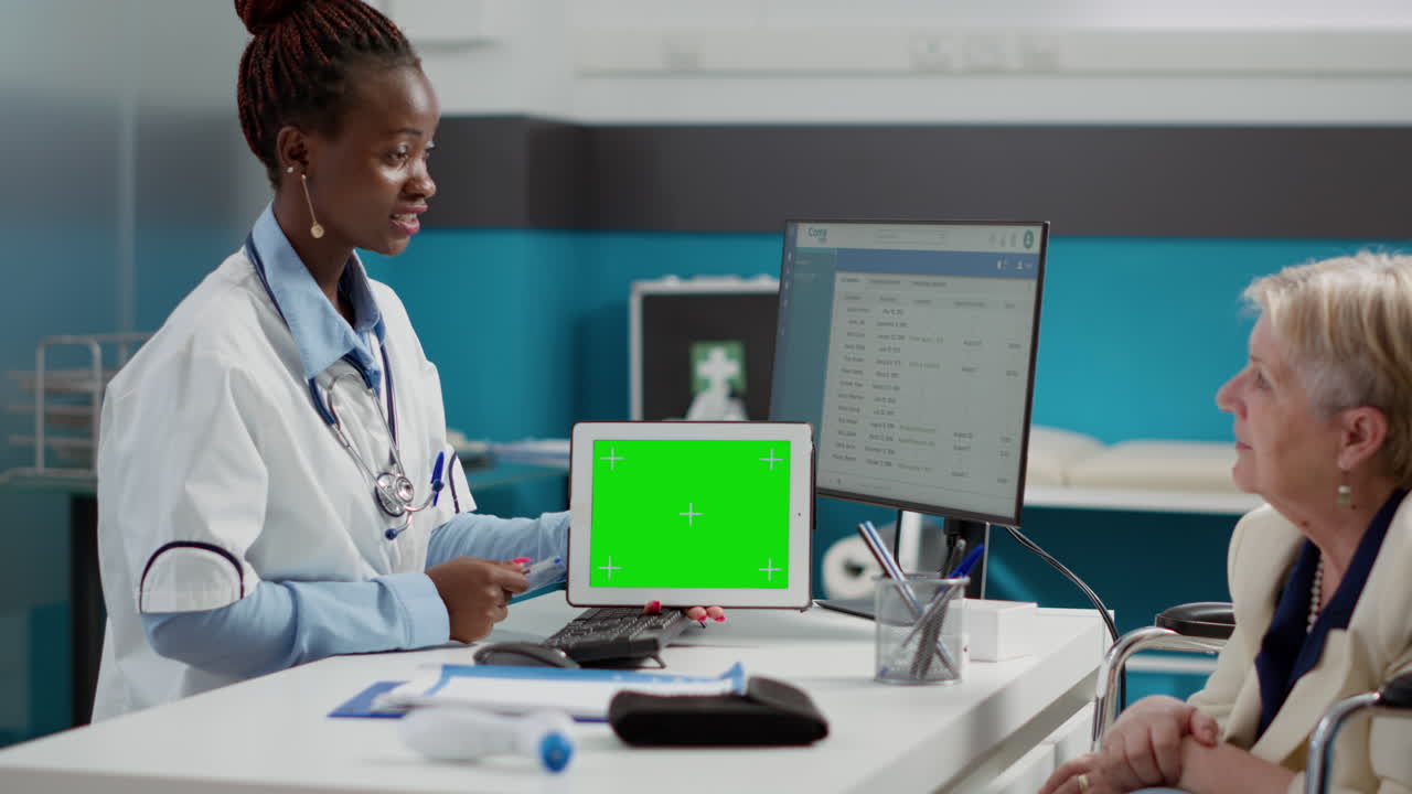 Doctor consulting with patient using tablet