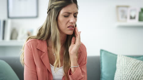 a woman experiencing a toothache while relaxing