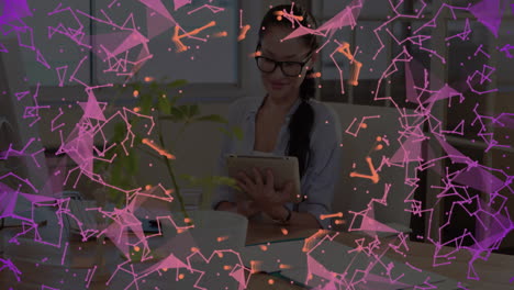 woman using tablet at office with plant, exploring network graphics overlay for technology design