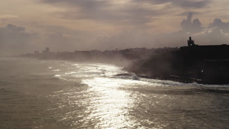 san juan, puerto rico coastline at sunset with fog