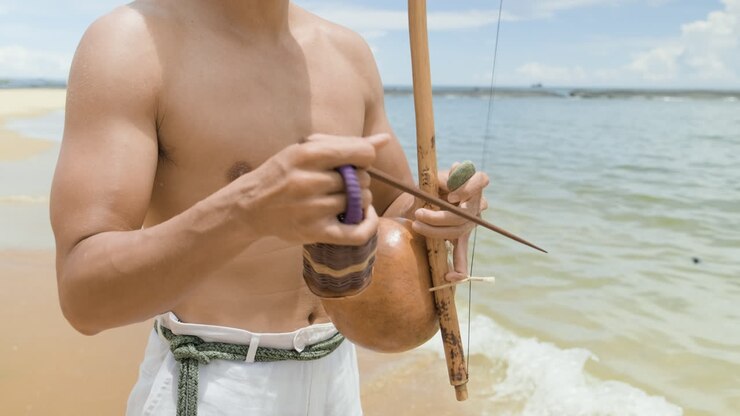 Shirtless man playing instrument