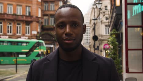 black male looking at camera on a busy london street