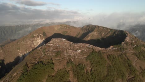 People-gather-along-rim-of-deep-volcano-crater-on-Mount-Batur-summit