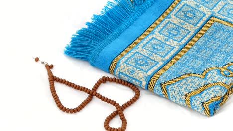 close-up prayer rug and rosary, islam and prayer rug, on the prostration muslims pray on,