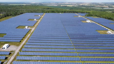 drone flying over solar panels on solar farm - green sustainable energy