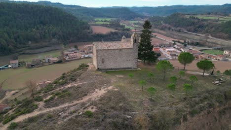 The-old-town-of-oristas-in-barcelona-with-a-historic-building-on-a-cliff,-aerial-view