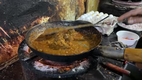 preparing mutton curry in an unhygienic kitchen at a dhaba in kolkata.