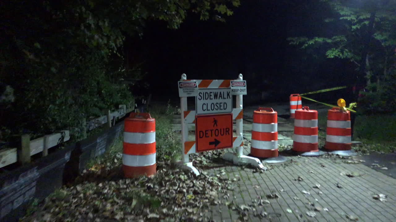 Walking down a brick path towards a detour sign