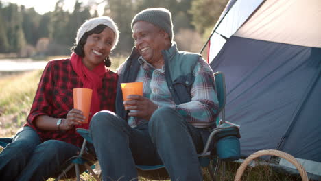 senior black couple on camping trip outside tent, close up