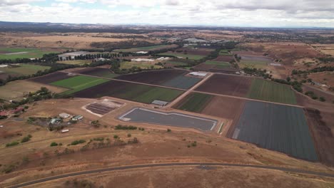 Fields-of-colourful-farmland-aerial-towards-rural-Australia