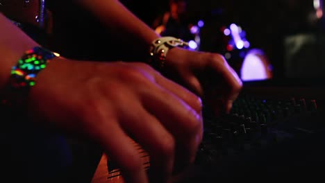 Woman-using-dj-mixer-at-nightclub-4k