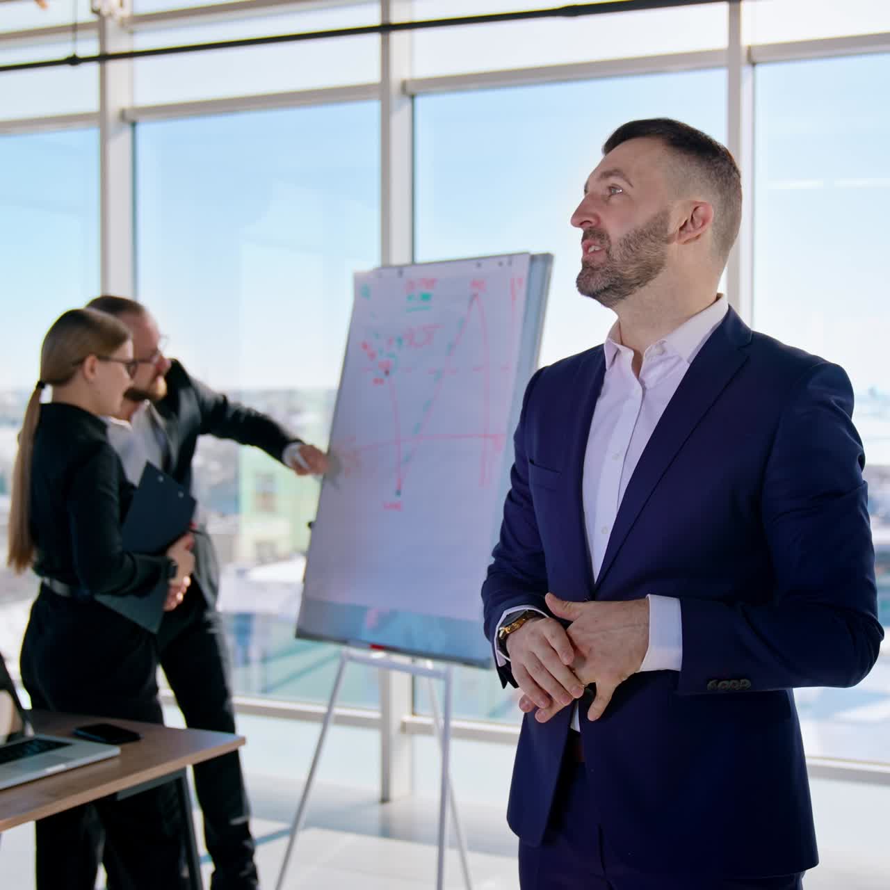 Successful entrepreneur man speaking. Professional businessman in suit talking on camera in office center. Business people work in office in the city