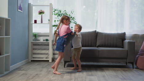 toddler and preschooler play with cushions in living room