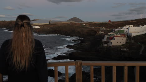 mujer joven admira el paisaje y los acantilados que se encuentra en el municipio de galdar en la isla de gran canaria y durante la puesta de sol