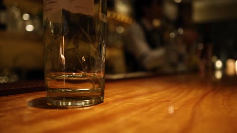 empty glass on wooden bar with blurred background