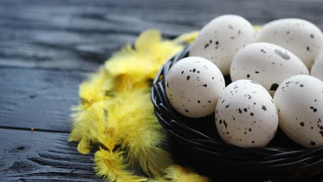 whole chicken eggs in a nest on a black rustic wooden background  easter symbols