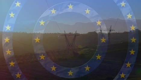 animation of stars from european union flag and map over electricity pylons in field