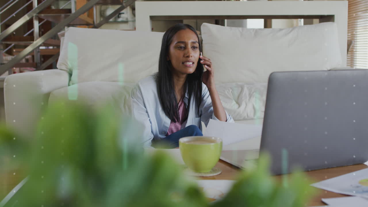 Animation of data processing over biracial woman using smartphone