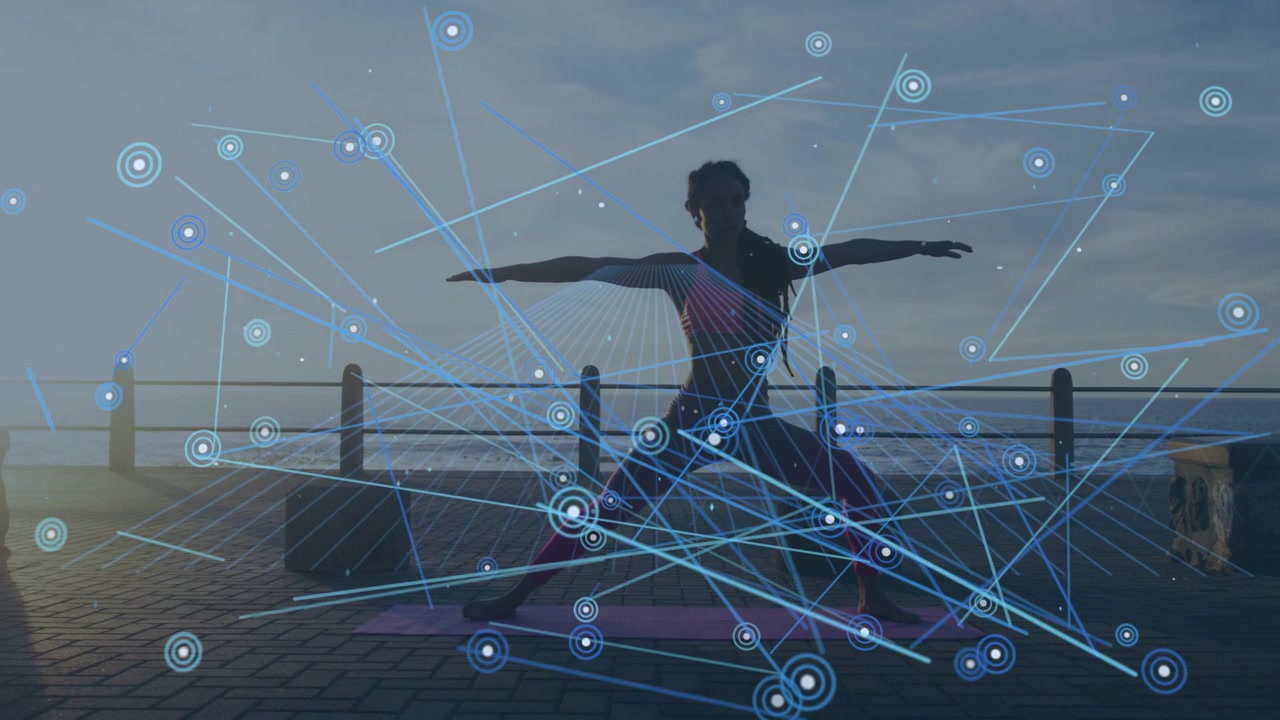 Woman doing yoga holding pose at seaside, shifting weight causing blue nodes linking for fitness