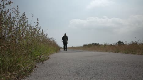 bald male with backpack walking along prince's walk in margate towards camera