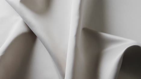 Close-up-of-white-shiny-silk-cloth-in-slow-motion