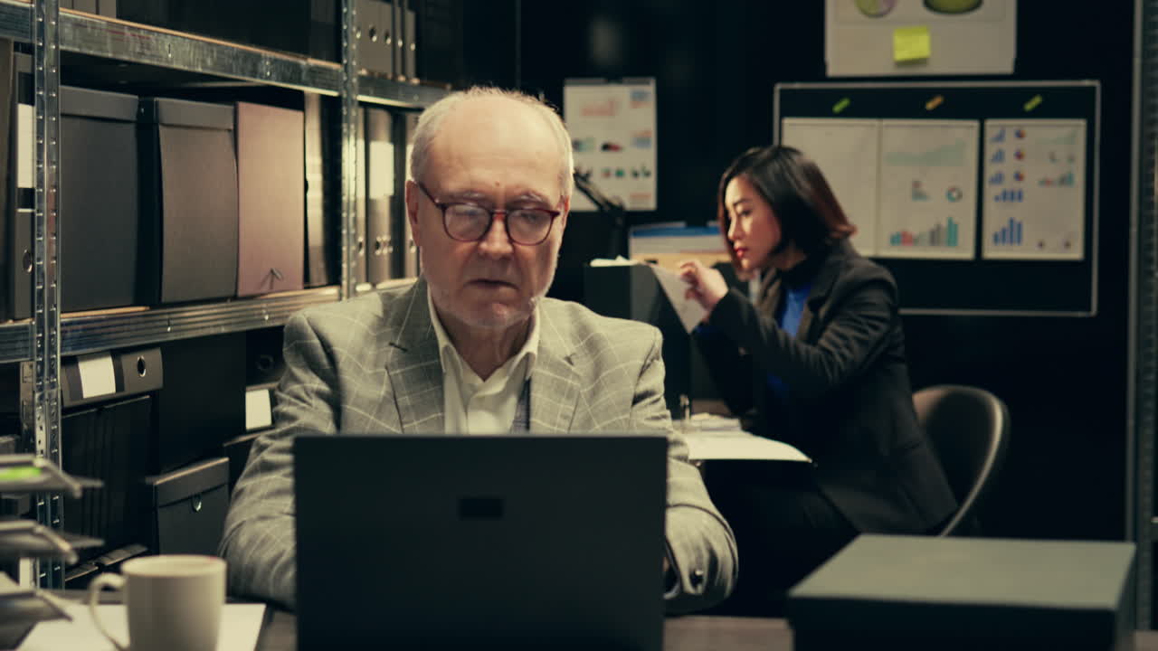 Senior law agent examining financial records to find account information