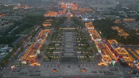 Aerial-drone-view-of-overseeing-vibrant-Datang-Everbright-City-at-dusk-with-beautiful-lighting