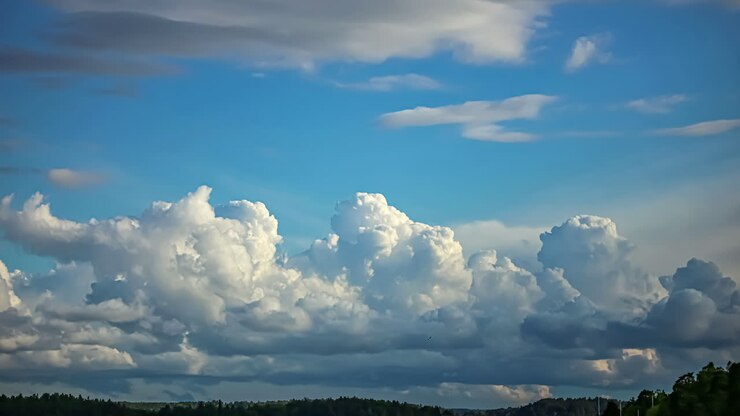 White Fluffy Clouds Moving In The Blue Sky