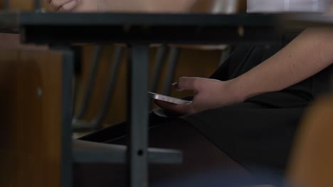student using smartphone in classroom