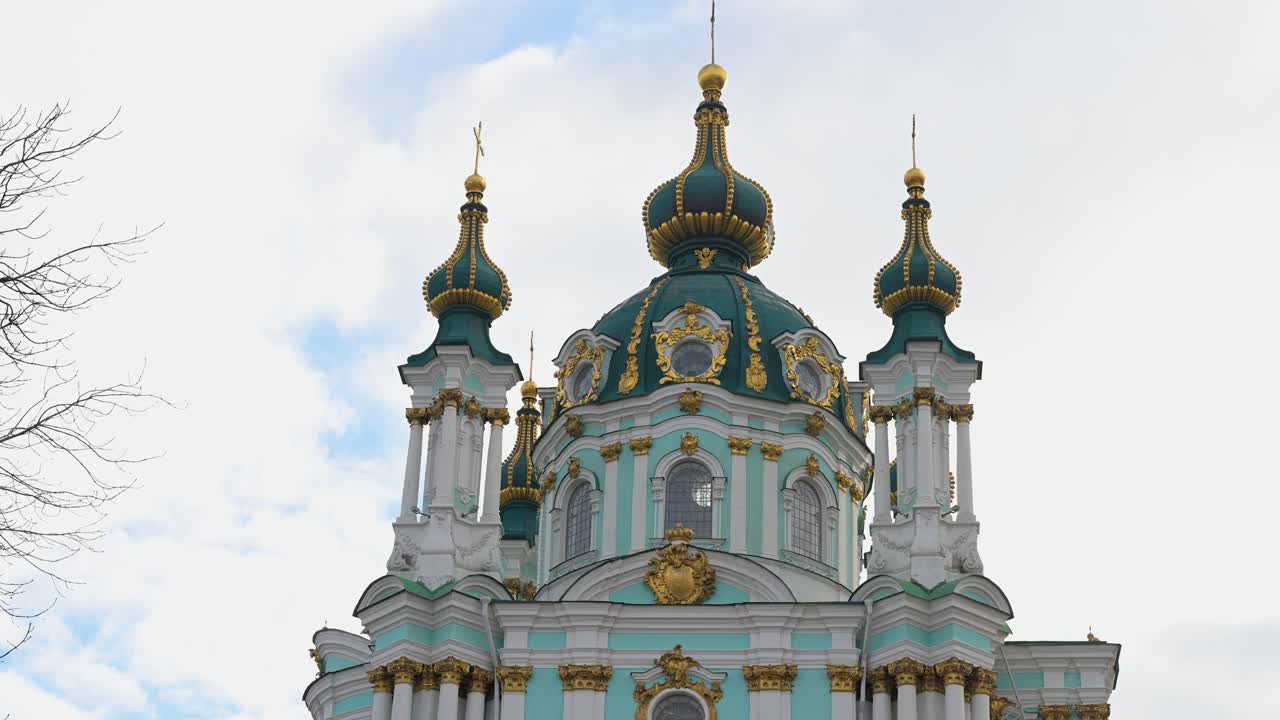 Low-angle view of the iconic turquoise and gold domes of St. Andrew's Church, a masterpiece of Baroque architecture in Kyiv, Ukraine. An exterior view of the famous historical landmark