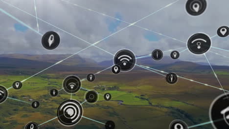 Animation-Verbundener-Symbole-über-Der-Luftansicht-Einer-Grünen-Landschaft-Mit-Bergen-Und-Bewölktem-Himmel