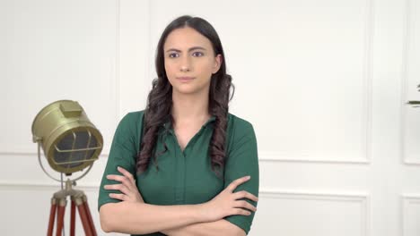 Confident-Indian-girl-standing-crossed-hands