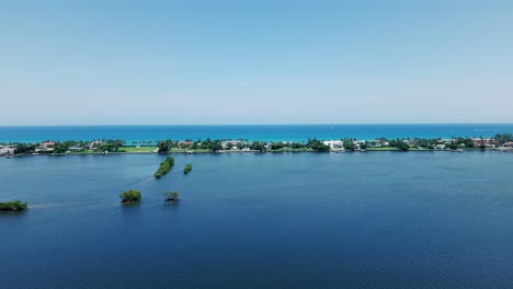 coastal flyover near downtown flagler beach showing ocean, trees, and city skyline