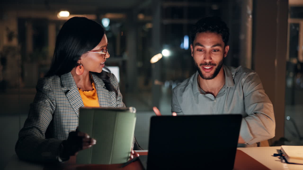 Business Colleagues Collaborating on a Project in a Dark Office