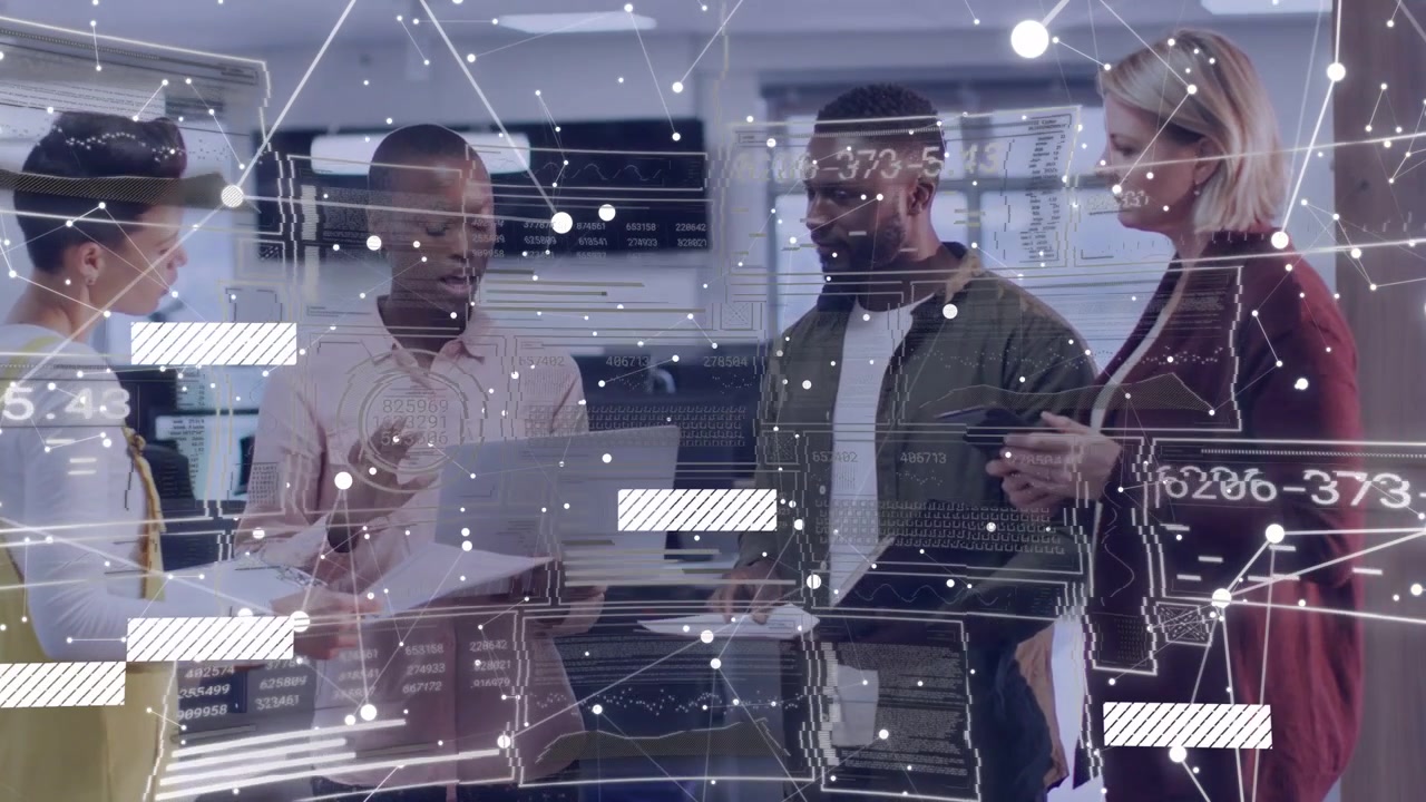 Reviewing four coworkers pointing at silver laptop in modern office, red blazer, network overlay