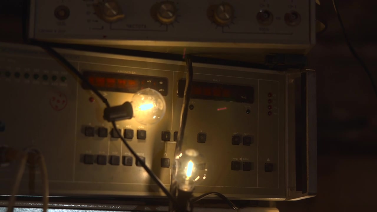 Vintage Equipment With Glowing Bulbs, Analog Meter And Tangled Wires On Workbench, Electrician Bench Testing