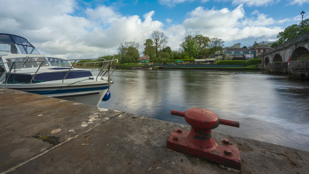 timelapse de carrick en la ciudad de shannon en el condado de leitrim y roscommon con tráfico, personas y nubes en movimiento en el río shannon en irlanda
