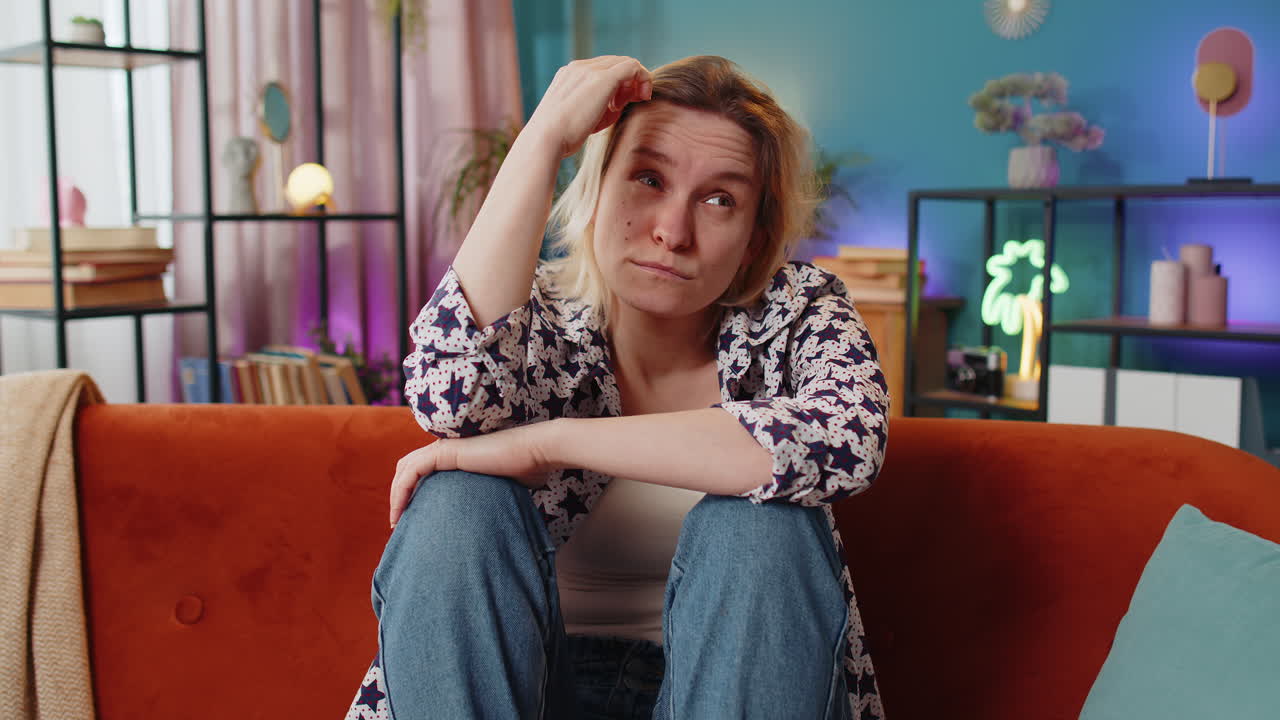 Sad lonely Caucasian woman looks pensive thinks over life concerns suffers from unfair situation