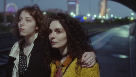 girls waiting for train in evening