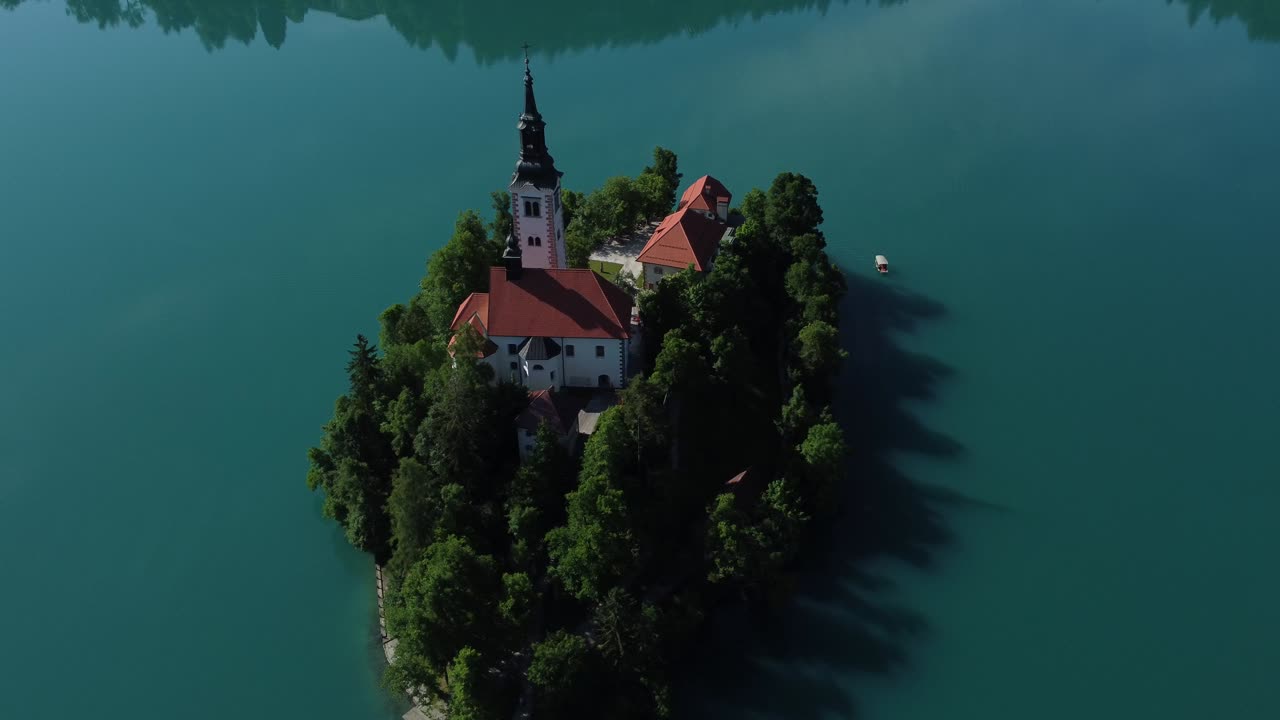 Romantico lago glaciale di Bled e isola dall'alto. Filmato video stock di alta qualità 4K ripreso con drone.